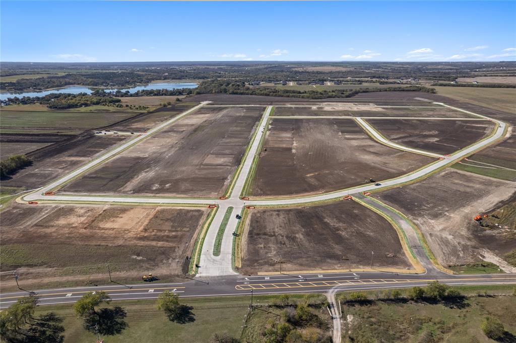 Cleared acreage featuring paved infrastructure, concrete curbing, and established roads