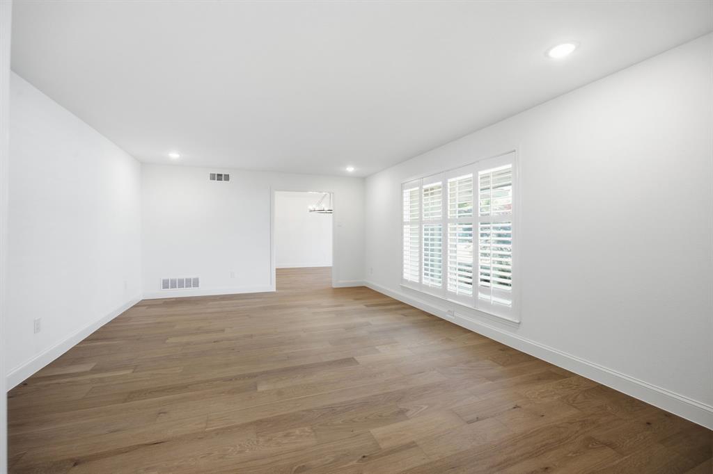 Open floor plan featuring wood-finish flooring, recessed lighting, and interior plantation shutters