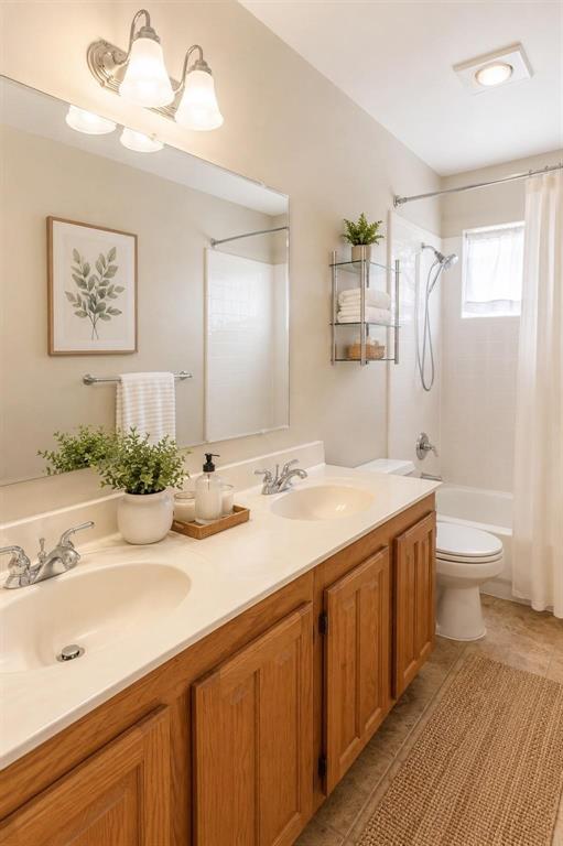 Updated bath with warm wood cabinetry, generous counter space and bright finishes.