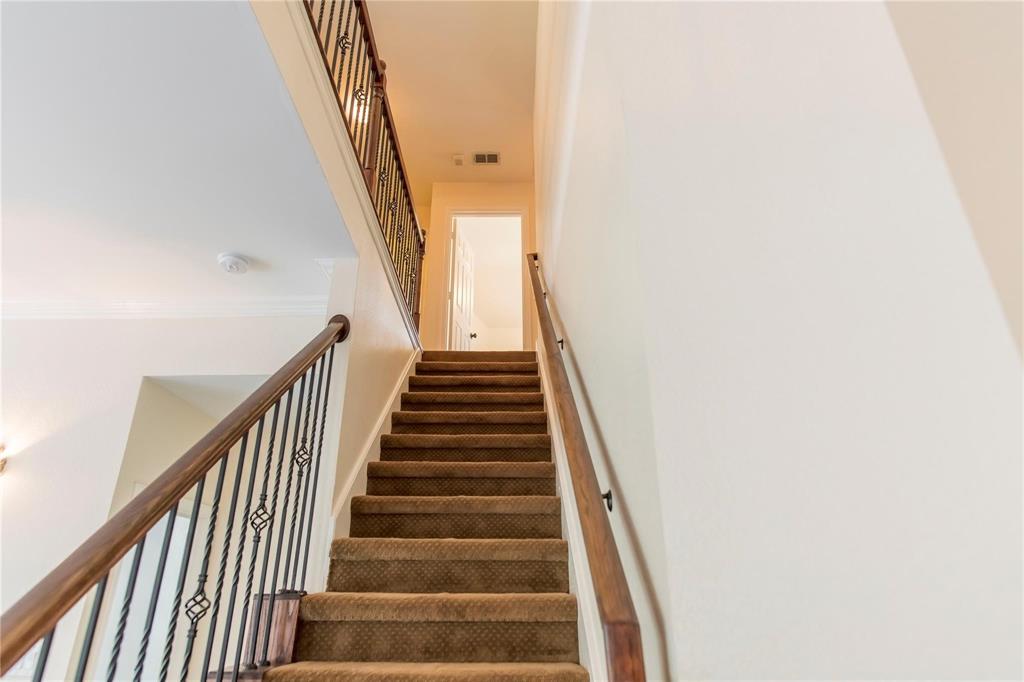 Staircase leads upstairs to three secondary bedrooms and the oversized game room.