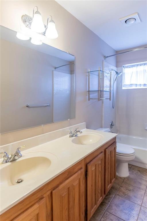 Clean, bright bathroom with long vanity and ample counter space.