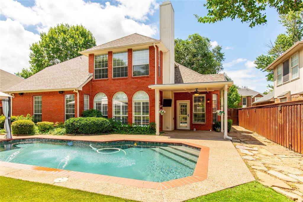 Resort-style backyard oasis! Sparkling private pool framed by a classic brick two-story - your own staycation every day.