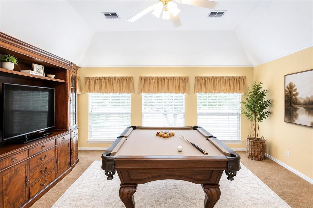 Spacious game room with built-ins and big windows - room for movie nights, hobbies or a home gym. Virtually staged.