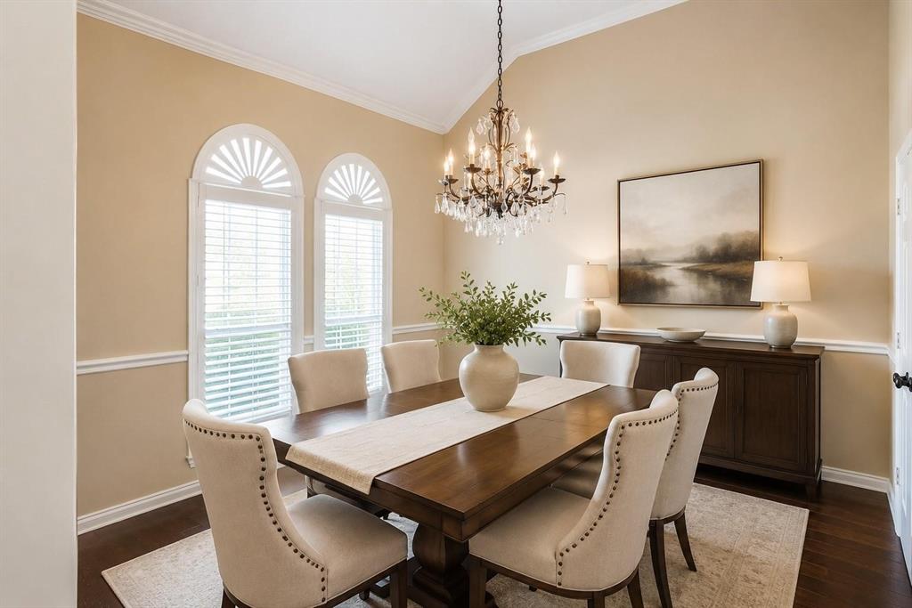 Elegant dining room with arched windows and statement chandelier - ready for dinner parties and holidays. Virtually staged.