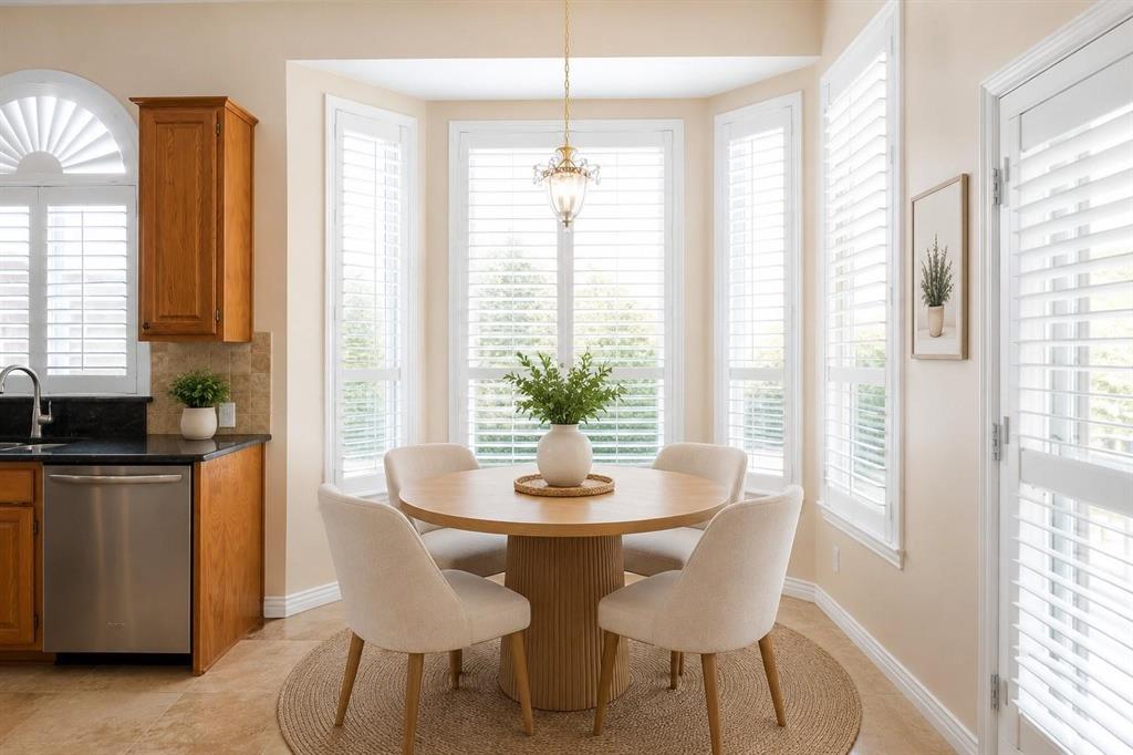 Sun-filled breakfast nook with bay windows - your new favorite spot for morning coffee. Virtually staged.