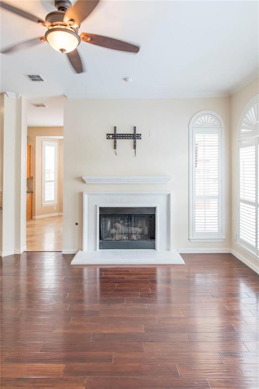 Cozy fireplace and high ceilings make this living space warm and welcoming.