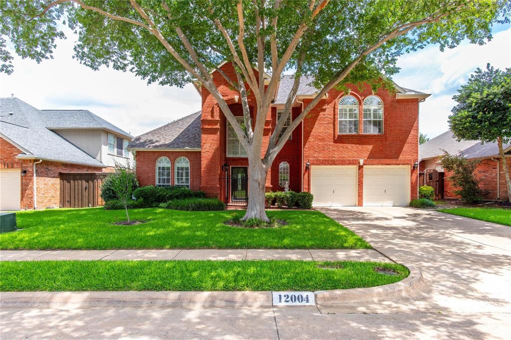 Stunning curb appeal! Timeless brick two-story with mature shade trees, manicured lawn and attached garage.