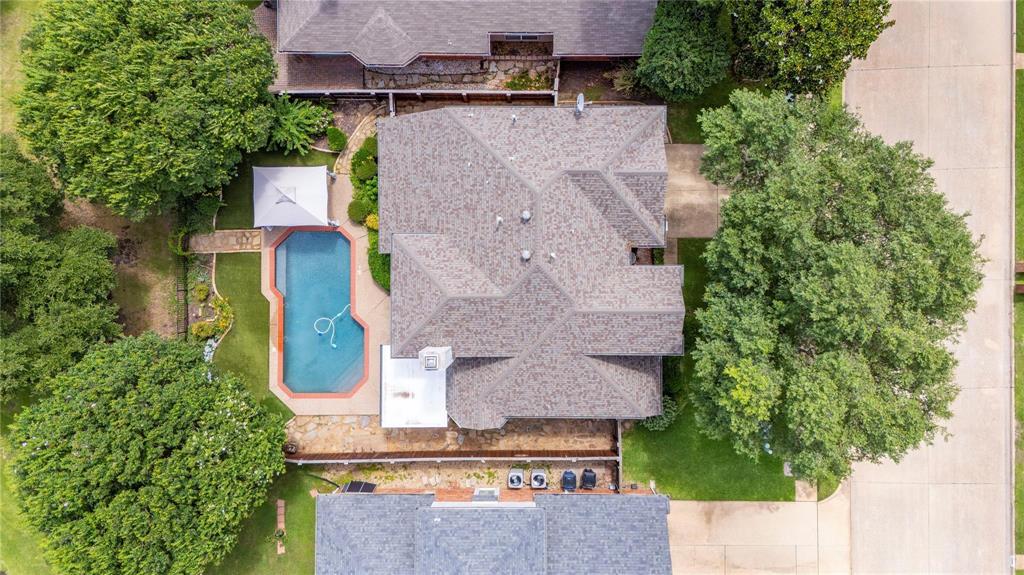 Aerial view showcasing the private pool, mature trees and golf course setting in Plantation Resort.