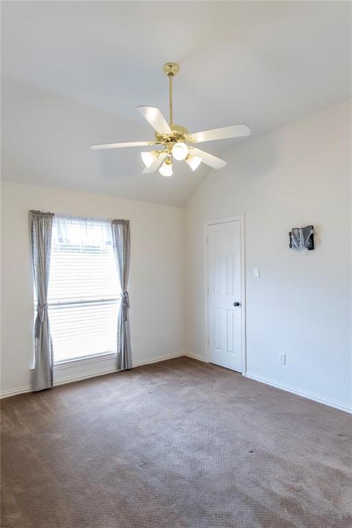 Comfortable bedroom with plush carpet and ceiling fan - plenty of space for furnishings.
