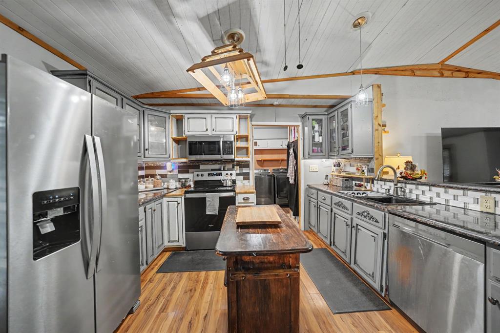 Kitchen featuring ample cabinet space and a center island for added prep space and functionality.