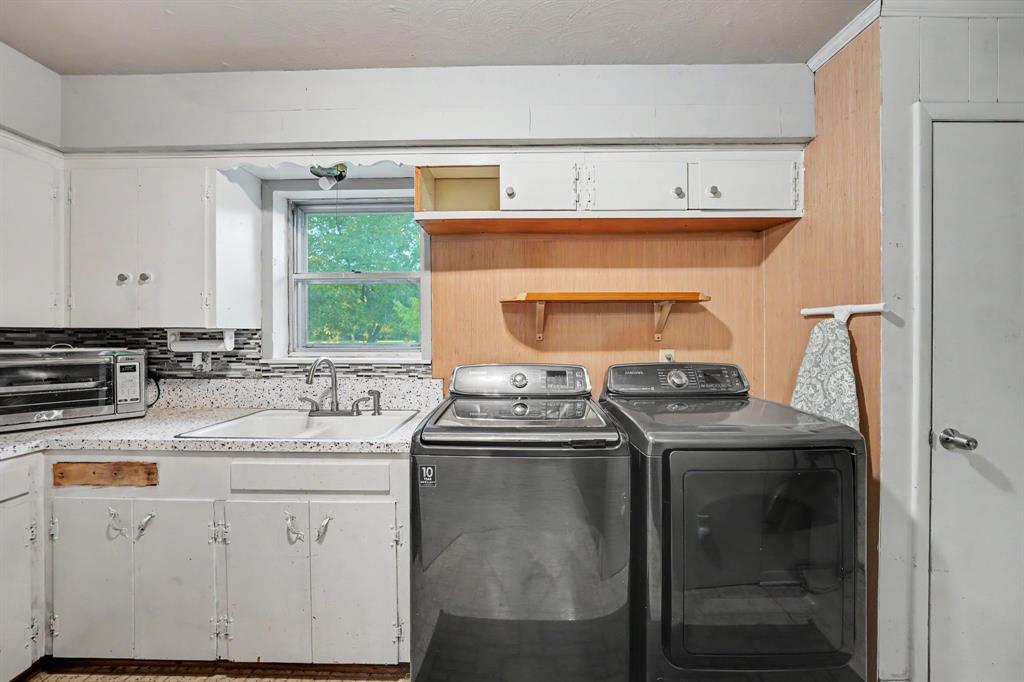 Spacious utility room with a second sink and additional pantry storage.