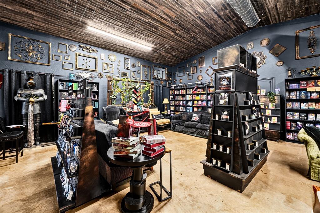Vaulted wood-plank ceiling, polished concrete flooring, and built-in shelving units