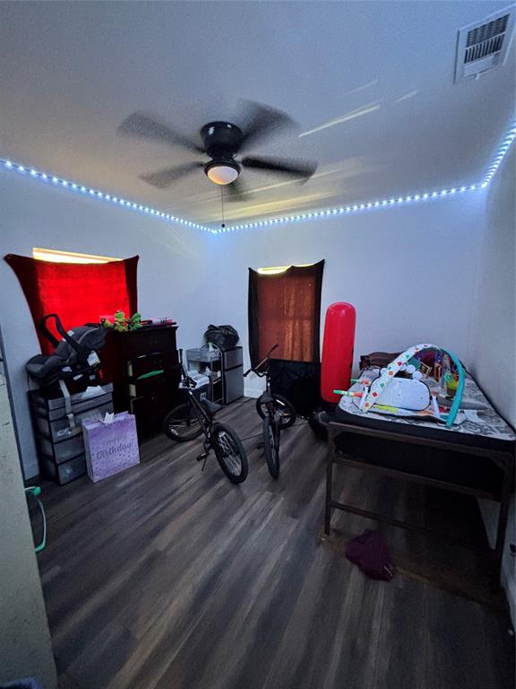 Interior space featuring wood-finish flooring and a central ceiling fan