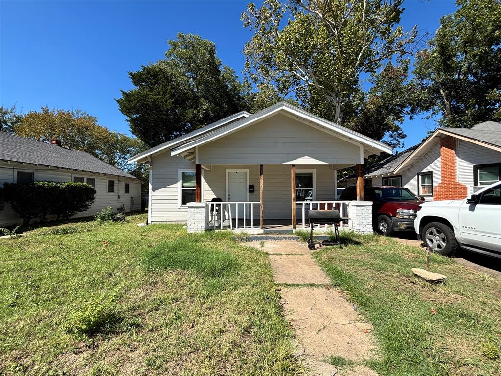 Single-story residence featuring horizontal siding, a covered front porch, white railings, and masonry porch pillars Single-story residence featuring horizontal siding, a covered front porch, white railings, and masonry porch pillars