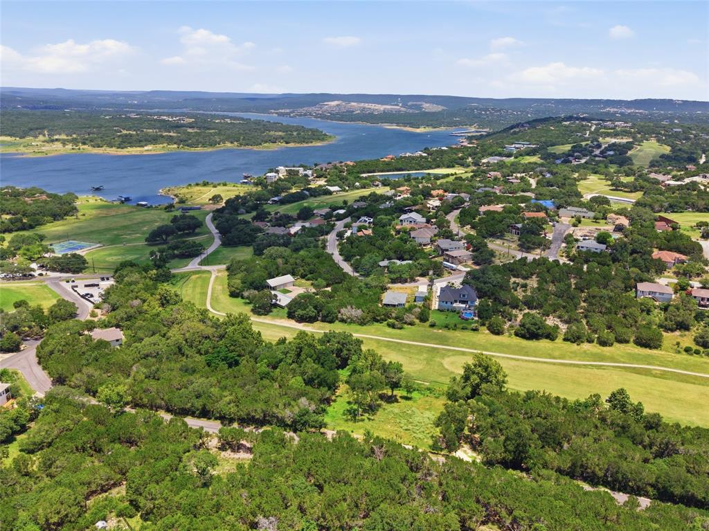 Aerial perspective featuring proximity to a large reservoir, expansive green space, mature tree canopy, and established road infrastructure