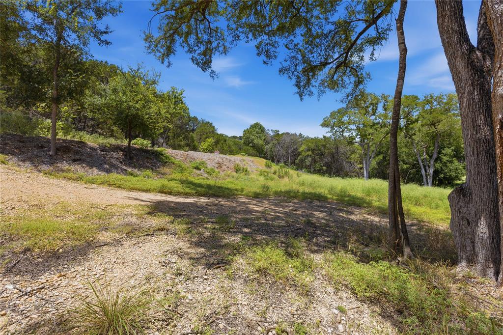 Expansive lot featuring mature native trees, natural gravel terrain, and varied topography