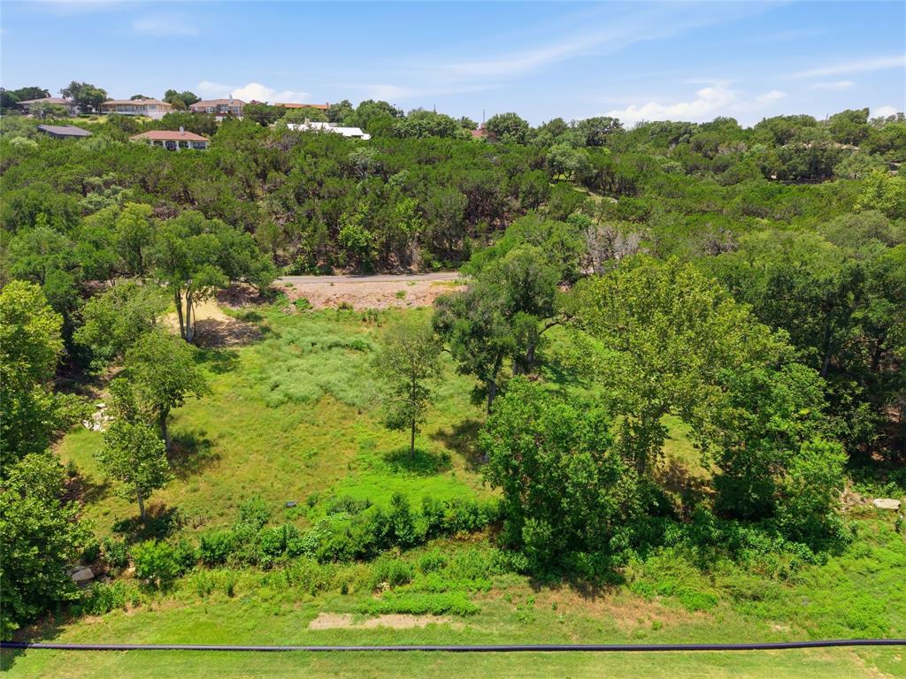 Expansive, undeveloped land featuring mature trees, native vegetation, and varied topography