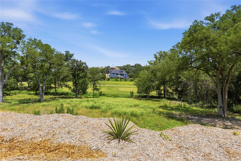 Expansive lot featuring mature hardwood trees and open green space
