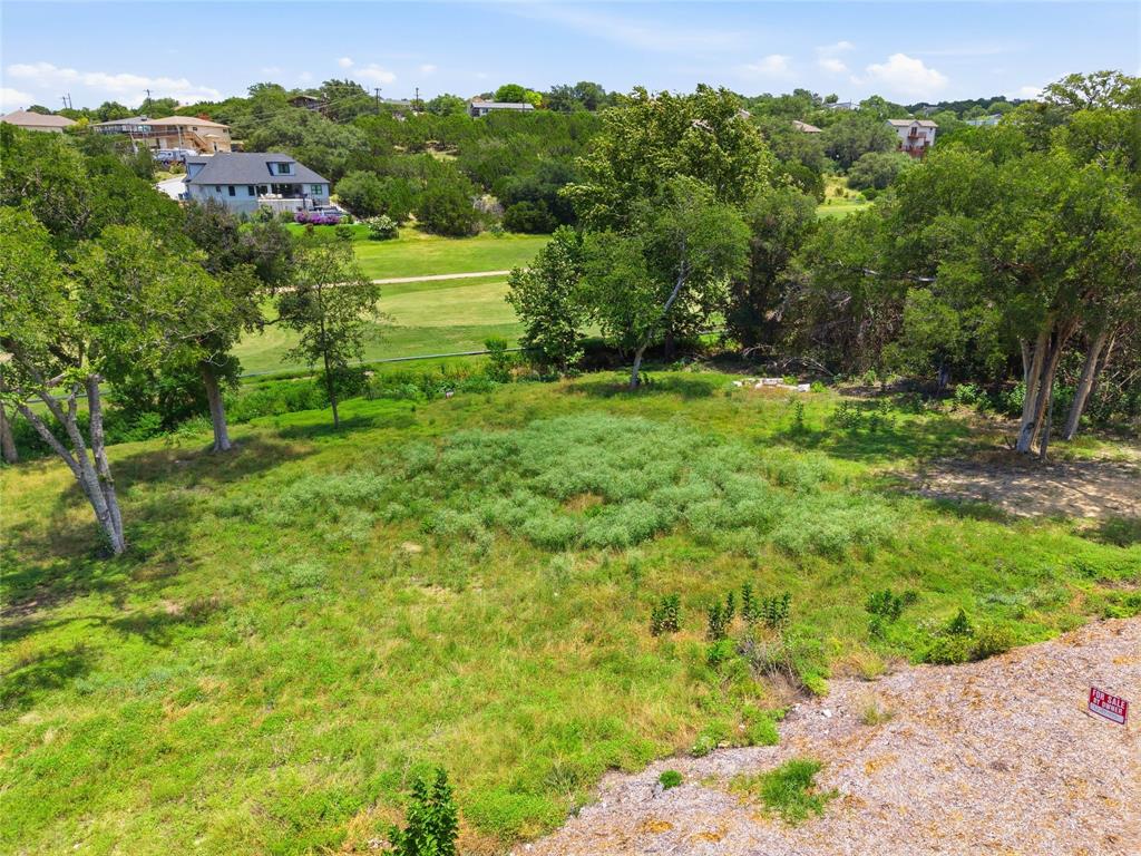 Expansive lot featuring mature trees, natural vegetation, and open green space