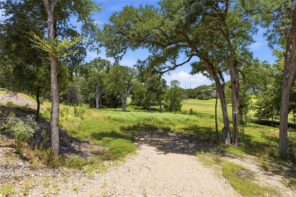 Expansive lot featuring mature trees, natural terrain, and native vegetation