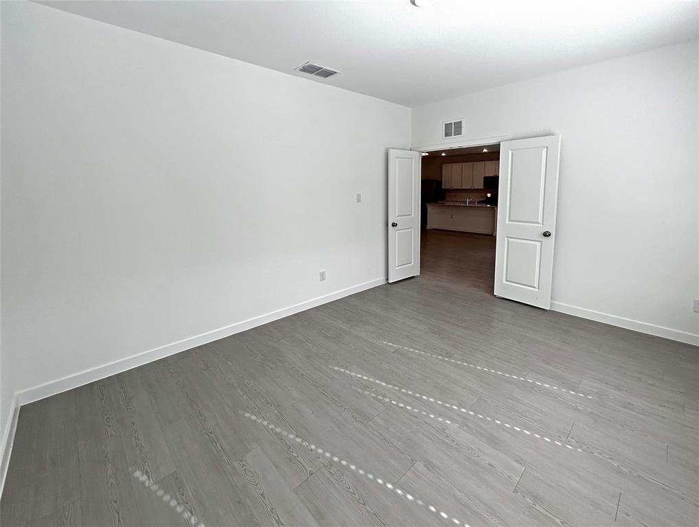 Neutral interior space featuring luxury vinyl plank flooring and two-panel interior doors