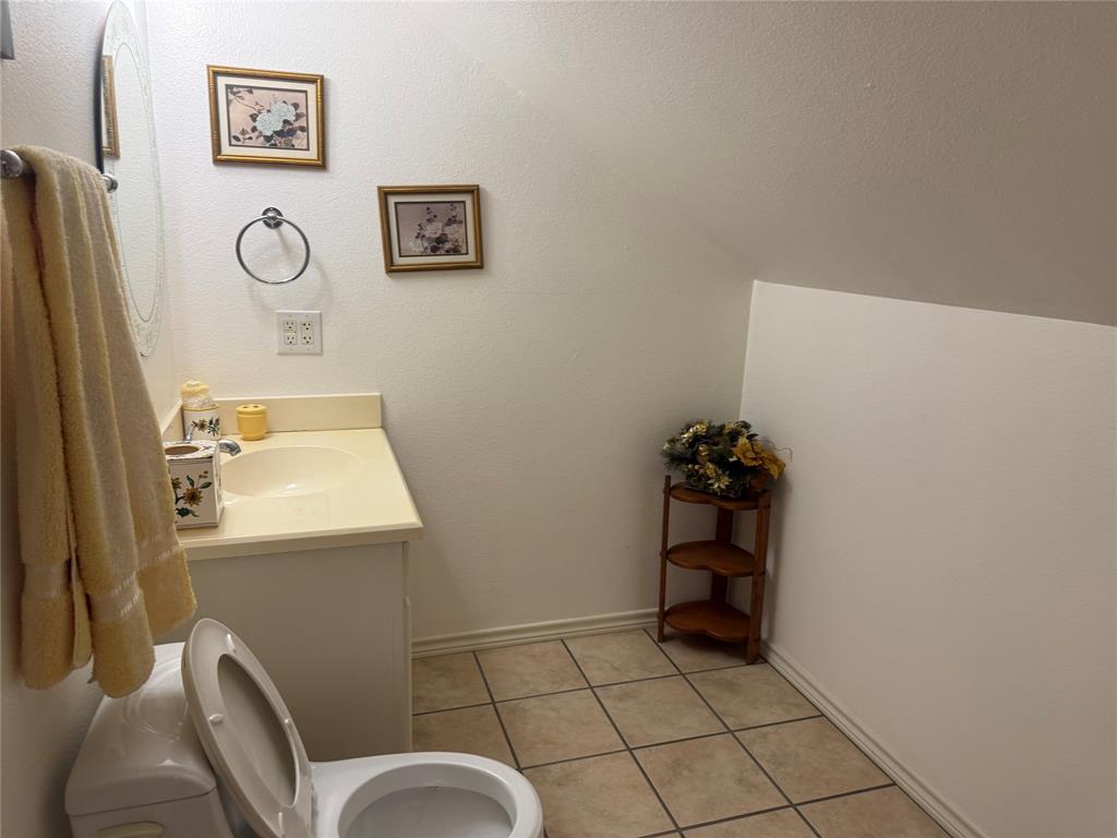 Bathroom featuring a vanity with an integrated sink, ceramic tile flooring