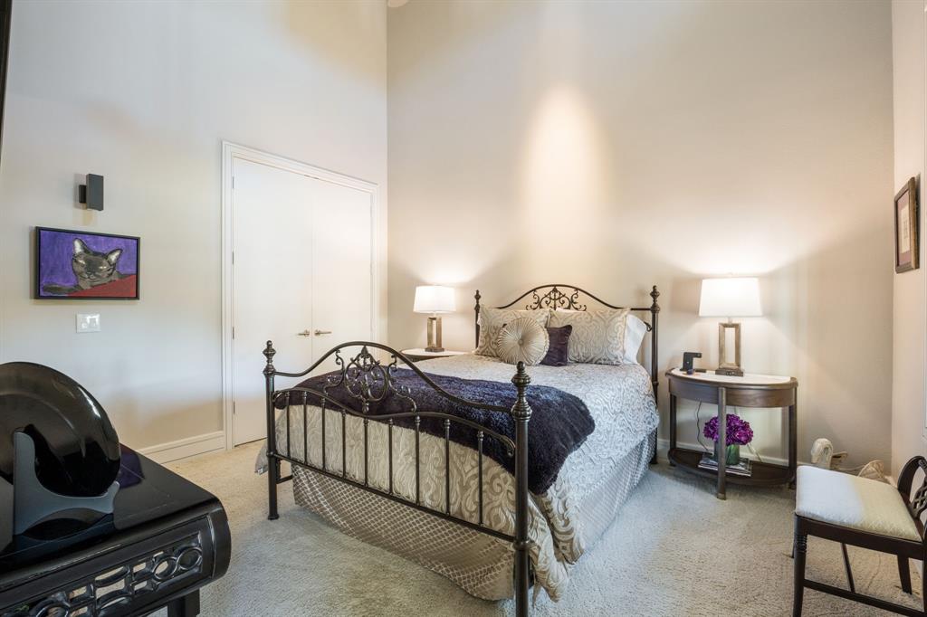 Vaulted ceilings, neutral wall color, wall-mounted light fixture, and double-door closet