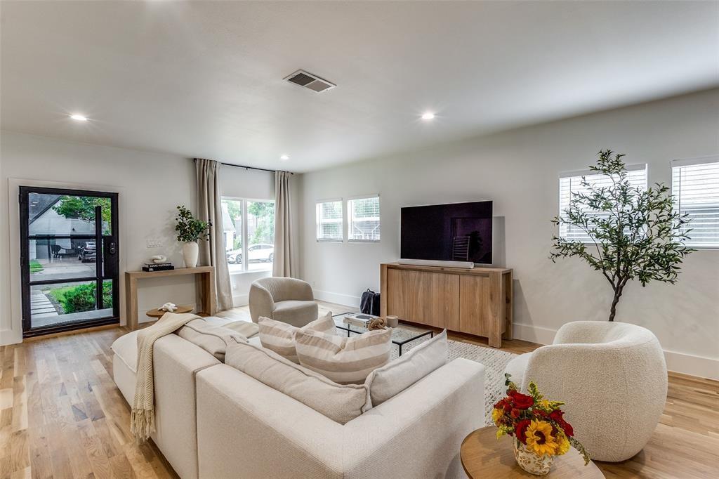 Interior living space featuring wood-finish flooring, recessed lighting, and a multi-pane glass entry door