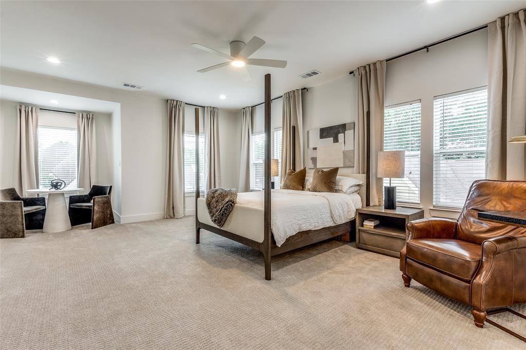 Neutral-toned wall-to-wall carpeting, recessed lighting, ceiling fan with integrated light, and multiple large windows with floor-to-ceiling drapery hardware