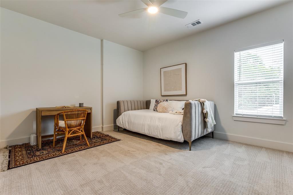 Neutral-toned carpeting, high ceilings, ceiling fan with integrated lighting, and a single-hung window featuring horizontal blinds