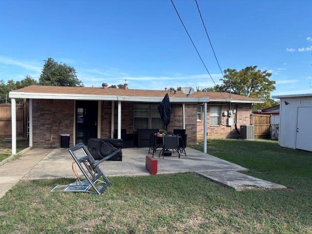 Brick exterior with a covered rear patio and a detached storage structure