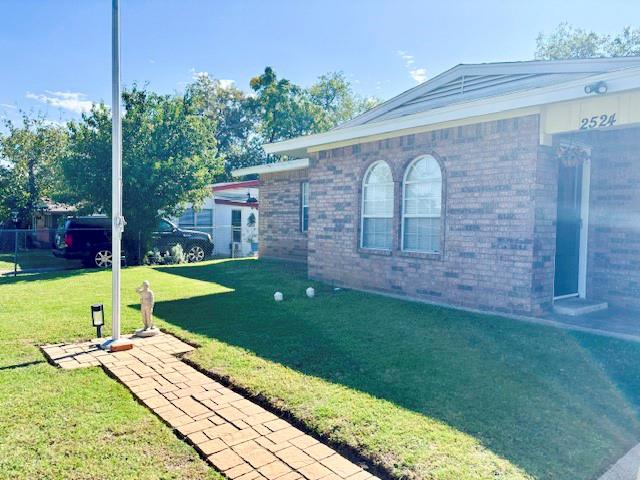 Brick exterior with paver stone walkway leading to flagpole