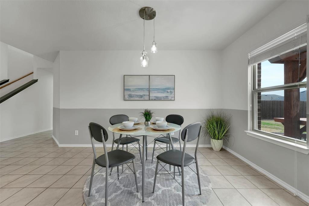 Dining room with light tile patterned floors and baseboards