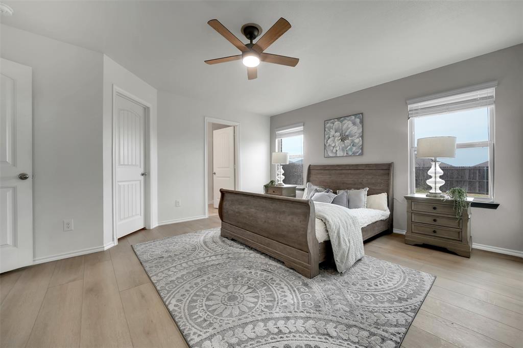 Bedroom featuring wood finished floors, baseboards, and ceiling fan