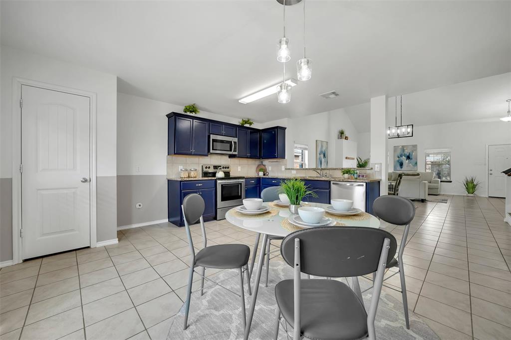 Dining space with light tile patterned flooring, visible vents, and a wealth of natural light