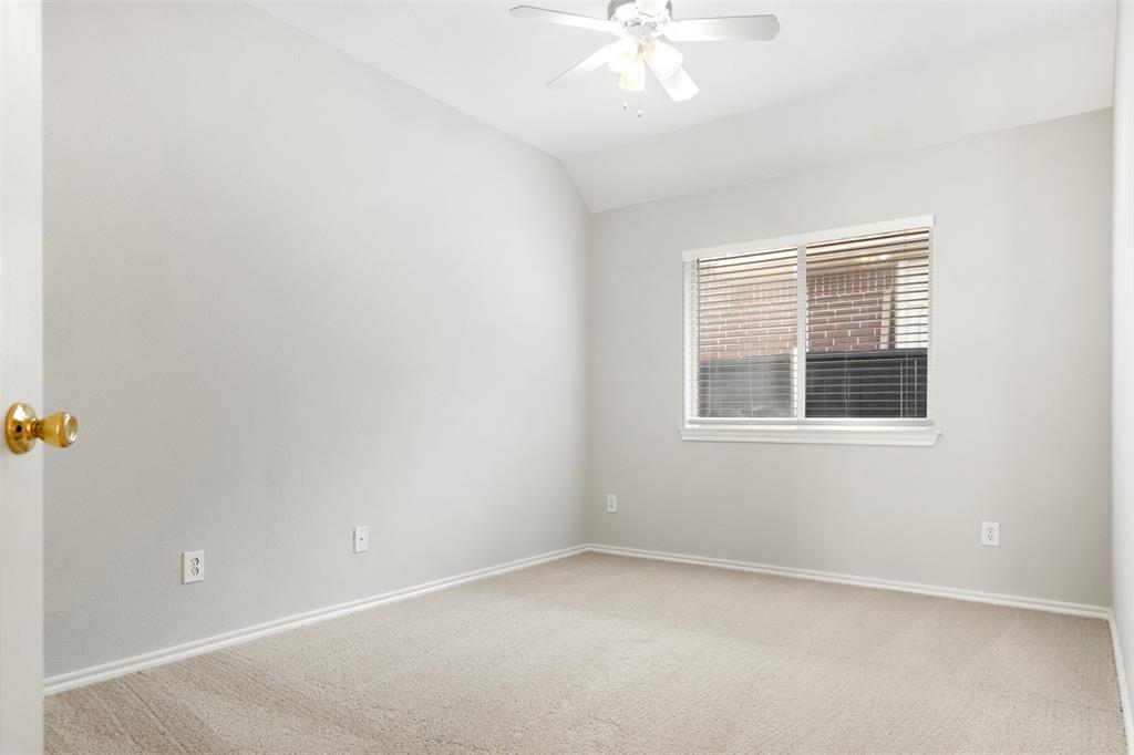 Neutral-toned room featuring high vaulted ceilings, wall-to-wall carpeting, and a central ceiling fan with an integrated light fixture