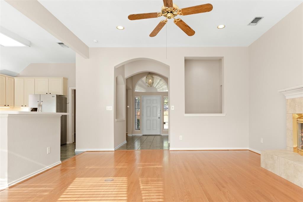 Interior featuring wood-finish flooring, recessed lighting, a ceiling fan, a built-in recessed wall niche, and an arched entryway