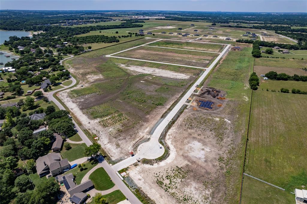 Cleared residential acreage featuring paved street infrastructure and proximity to open water