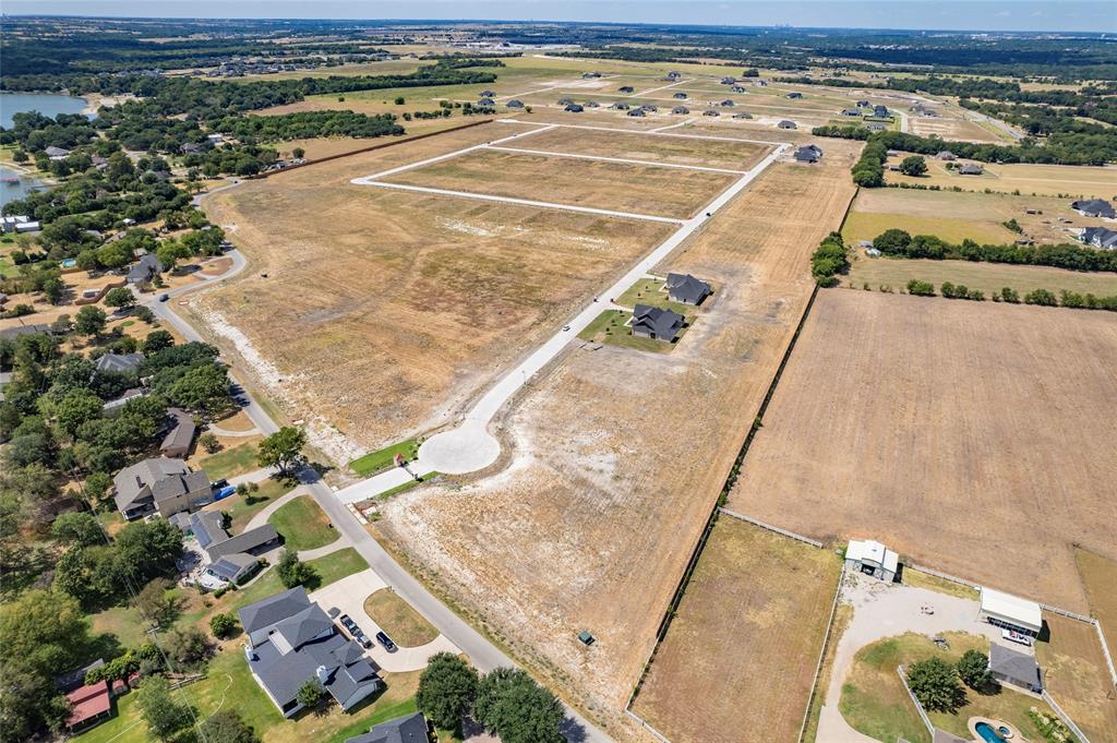 Expansive undeveloped acreage featuring paved street infrastructure, cul-de-sac access, utility access points, and proximity to open water