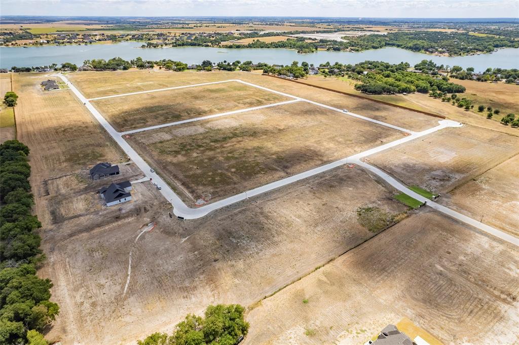 Expansive land parcels featuring concrete street infrastructure, cleared building sites, and water frontage