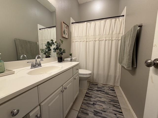 Vanity featuring a white countertop with an integrated oval sink, dual-handle chrome faucet, wall-mounted mirror, and white shaker-style cabinetry