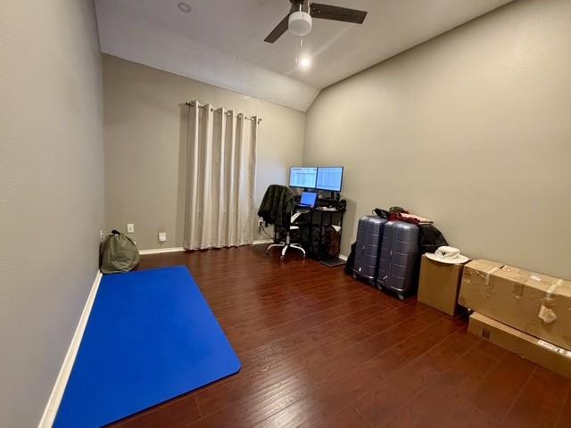 Vaulted ceilings, wood-finish flooring, and a ceiling fan with integrated lighting