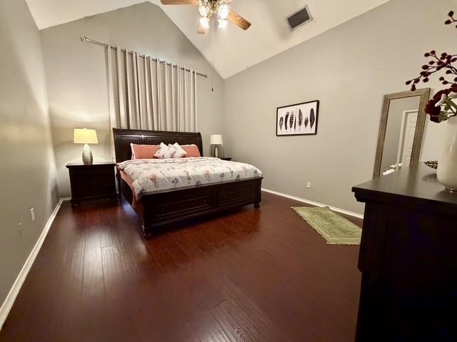 Bedroom featuring vaulted ceilings, wood-finish flooring, and a ceiling fan with integrated lighting