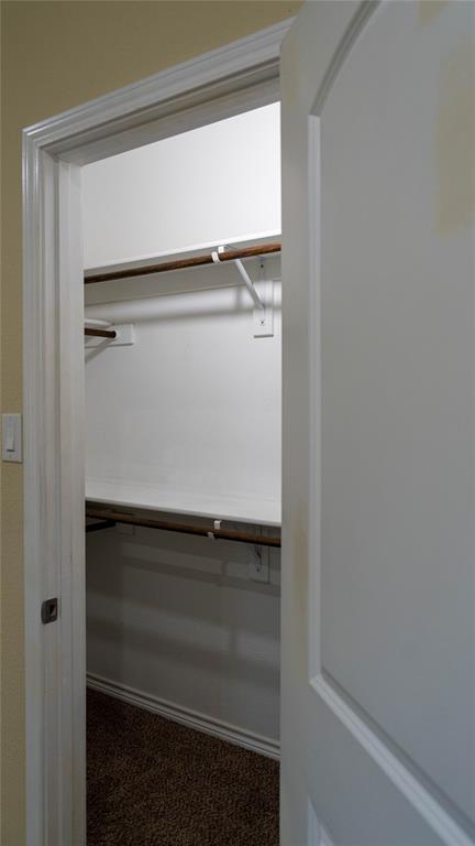 Primary bedroom walk-in closet