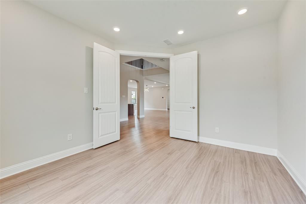 Interior space featuring wood-finish flooring, recessed lighting, and double-panel doors