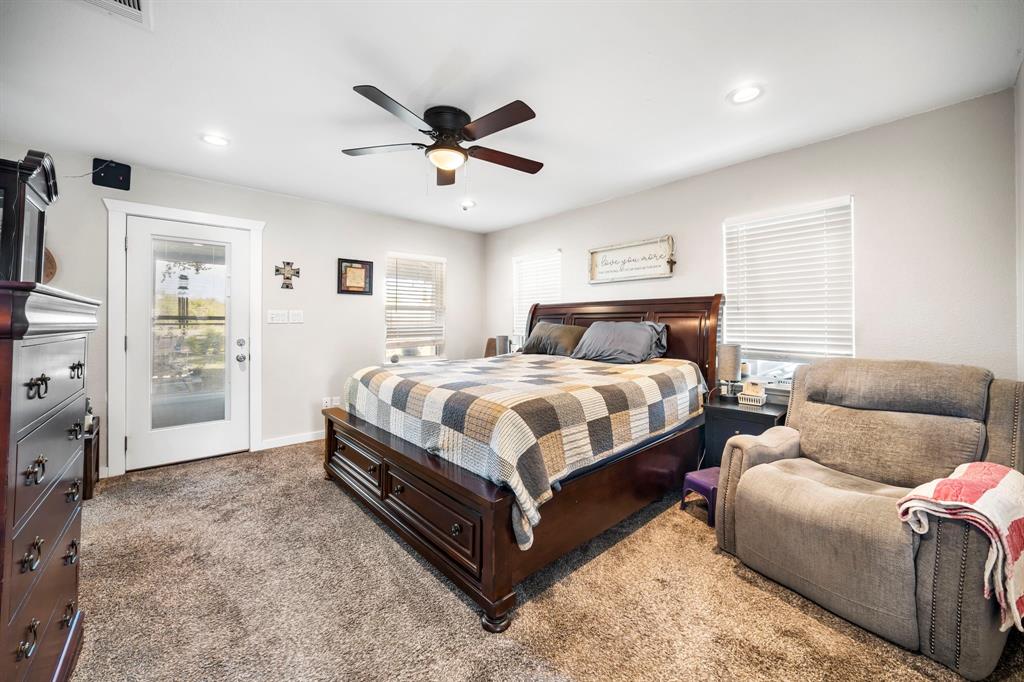 Neutral-toned wall color, recessed lighting, ceiling fan, carpeting, and glass-panel door
