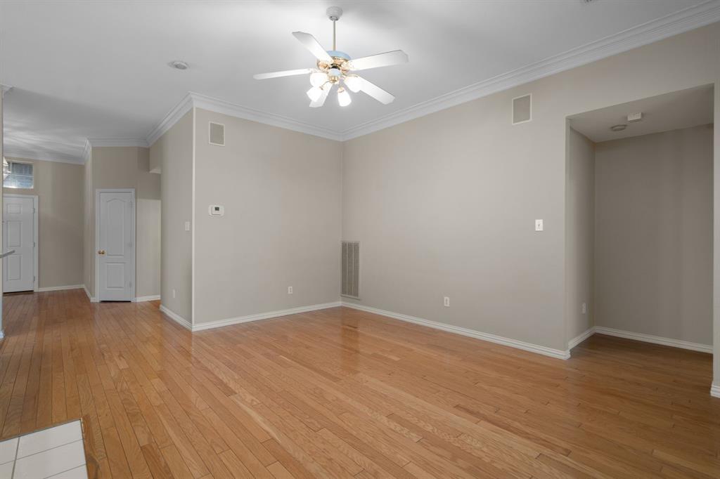 Unfurnished room with a ceiling fan, light wood-type flooring, and crown molding