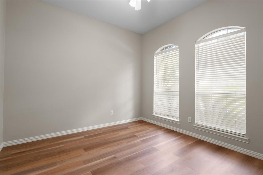 Empty room featuring light wood-type flooring and ceiling fan