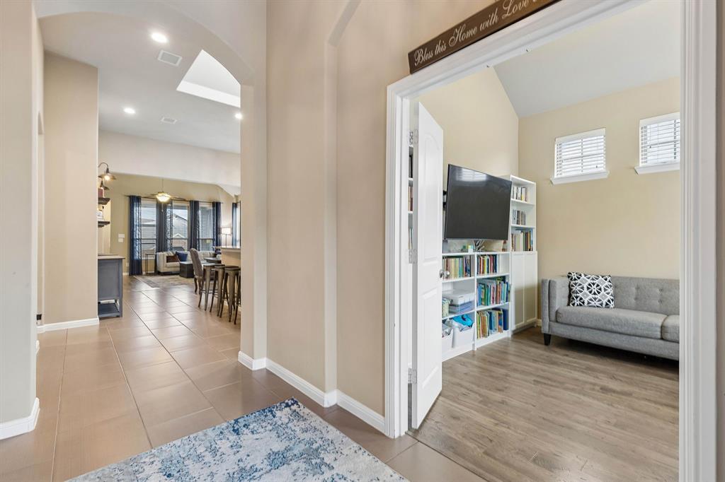 As you enter the home, you'll find the private office immediately to your right, featuring tile floors, a decorative light and elegant French doors that create a warm and inviting entrance.