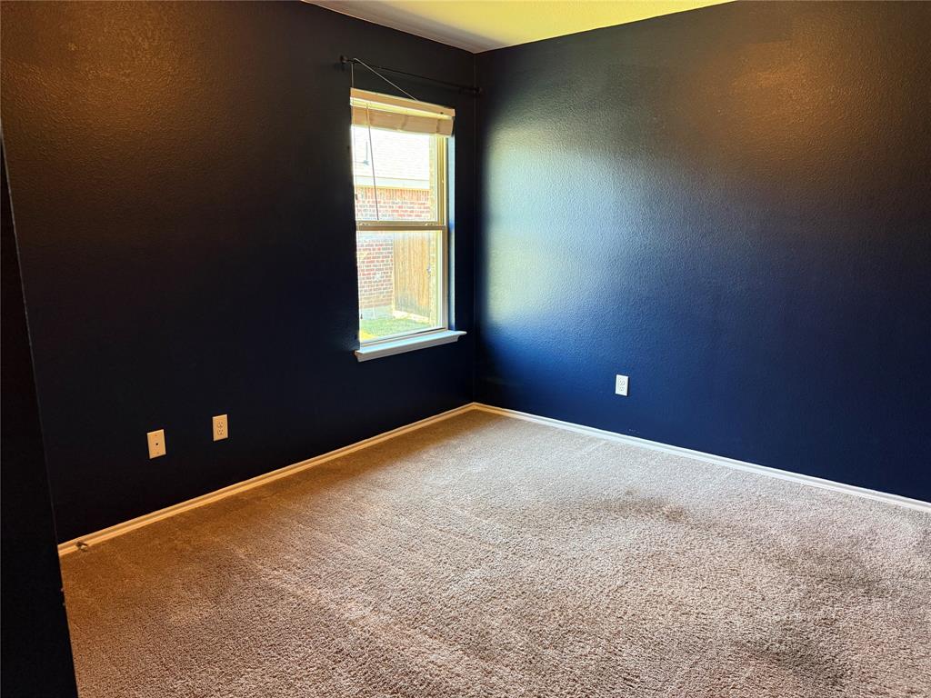 Interior space featuring wall-to-wall carpeting and a single hung window with a white sill